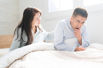 起きてベッドの上で会話をする夫婦