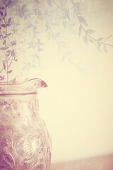Vintage floral pitcher with botanical overlay