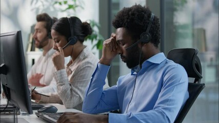 Frustrated multiethnic operators callcenter business crisis computer headache Caucasian African men depressed sad agent headset failure service bad call center Hispanic woman helpline support office - Powered by Adobe