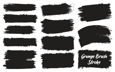 Collection of black grunge brush strokes and paint splatters on a white background