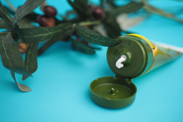 Cream tube beside olive plants 