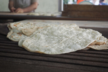 Fresh flatbreads on a wooden surface