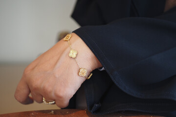 Elegant gold bracelet worn on wrist in a cozy setting