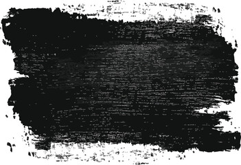 Fototapeta premium A horizontal black paint brush stroke with rough edges on a white background in a close up shot