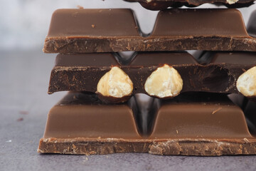 Chocolate bars with nuts stacked for a sweet treat