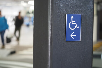 Parking sign indicating accessible space in busy area