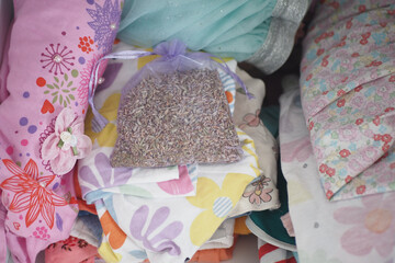 Lavender sachet placed among colorful bedding items