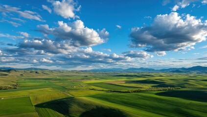 Obraz premium Panoramic view of a valley with fields and mountains