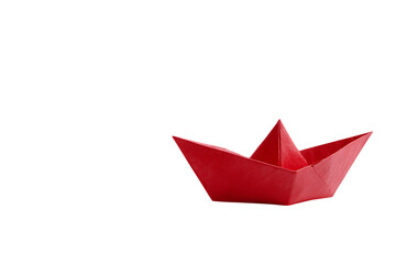 A small red paper boat on a black background.