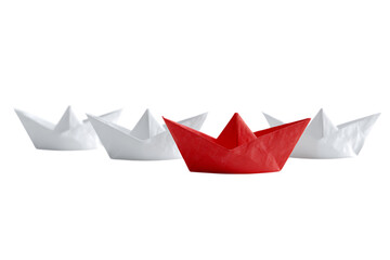Red paper boat leads a fleet of white ones.  Metaphor for leadership and standing out.