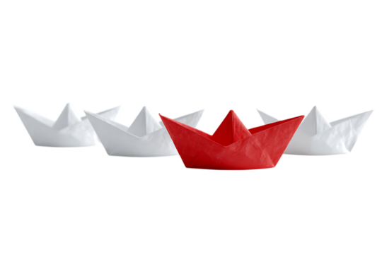 Red paper boat leads a fleet of white ones.  Metaphor for leadership and standing out.