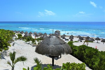 Cancun beach with umbrellas and chairs