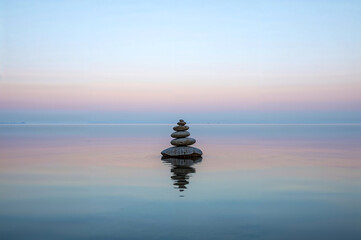Perfectly Balanced Stone Cairn on Still Water at Dawn: Zen Serenity