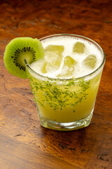 A refreshing Kiwi Margarita cocktail with lime zest rim and fresh kiwi slice garnish, a tropical...
