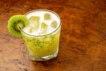 A refreshing Kiwi Margarita cocktail with lime zest rim and fresh kiwi slice garnish, a tropical...