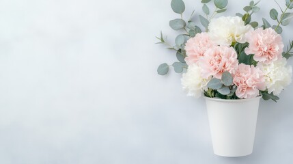 Fototapeta premium Soft Petals in Pastel: A gentle arrangement of carnations, in soft pink and white, spills gracefully from a pristine container. The flowers, a symbol of love and admiration.