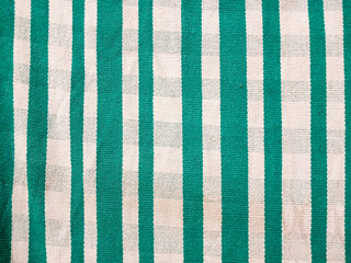 Rustic and handmade cloth, with green and white stripes, typical of sleeping hammocks, woven with cotton threads by peasant women in the state of Maranhão, northeast of Brazil.