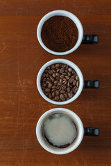Layers of Coffee: Ground Coffee, Beans, and Fresh Brewed Cup
