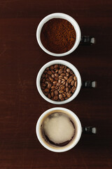 Three Stages of Coffee Preparation: Grounds, Beans, and Brewed Drink