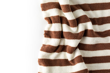 Obraz premium Soft Brown and White Striped Fleece Blanket on a White Background