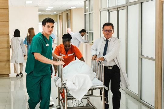 Medical team rushes patient on stretcher through hospital corridor during emergency case. Focus on fast response, urgency, healthcare teamwork, and critical care in a modern medical facility. - Powered by Adobe