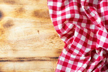 Red and White Checkered Tablecloth on Rustic Wooden Background