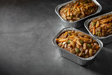 Delicious homemade dessert with mixed nuts and fruits in containers