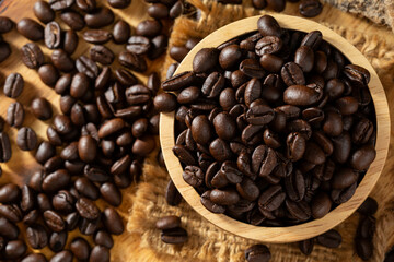 Roasted Coffee Beans in a Wooden Bowl with Spilled Grains