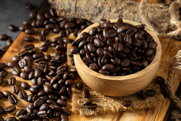 Fototapeta premium Freshly Roasted Coffee Beans in a Wooden Bowl on Rustic Background