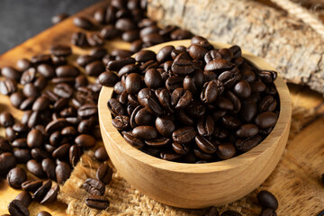 Fototapeta premium Freshly Roasted Coffee Beans in Wooden Bowl on Rustic Background