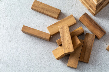 Wooden Block Stacking Game Pieces on Light Surface Background