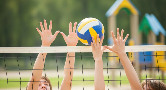 focused children jump with raised hands competing for ball at spirited outdoor volleyball game on sunny day, teamwork and active play at school playground