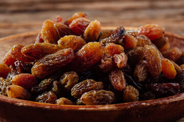 Dried Fruit Bowl Filled with Juicy Natural Raisins on Wooden Table