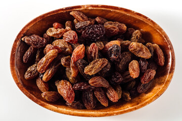 Assorted Dried Raisins in Wooden Bowl on White Background