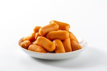 Stack of Juicy Orange Sausages on a White Plate Isolated Background