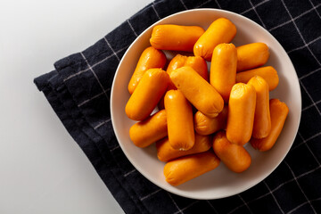 Assorted Orange Snacks on Plate with Black Checkered Background