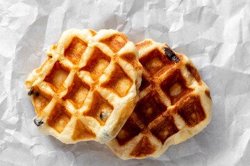 Deliciously Golden Fresh Waffles on Crinkled White Paper Surface
