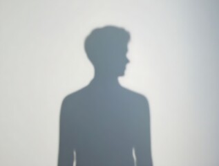 Shadow of a person on a clean background evokes mystery, introspection, and the exploration of identity and anonymity