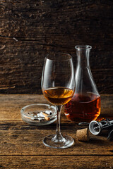 Elegant Glass of Amber Liquor with Decanter and Ashtray