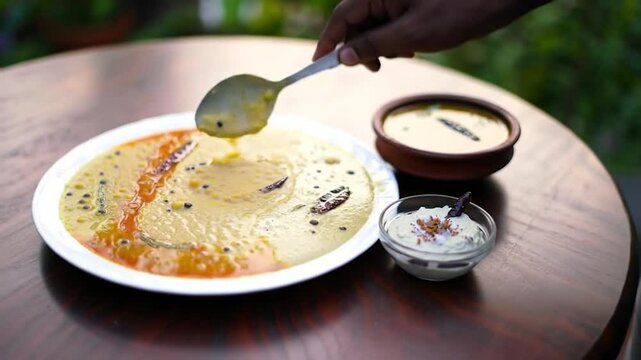 Ven Pongal Khara Pongal Sambar coconut chutney man hand serving Indian breakfast food Tamil Nadu festival Pongal Sankranti