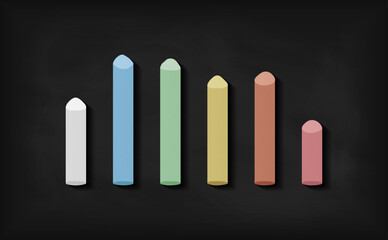 Chalk colorful pieces stick on blackboard background