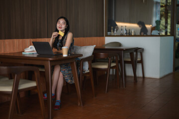 Freelancer enjoying online shopping with credit card and laptop in cafe