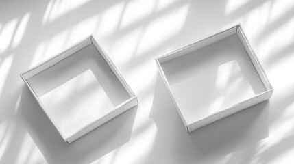 Two empty white square boxes on a light surface.