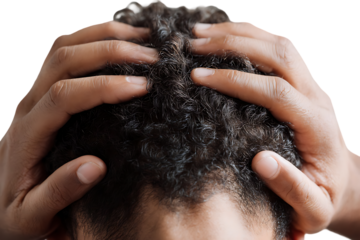 Close up of a person's hands on their head.