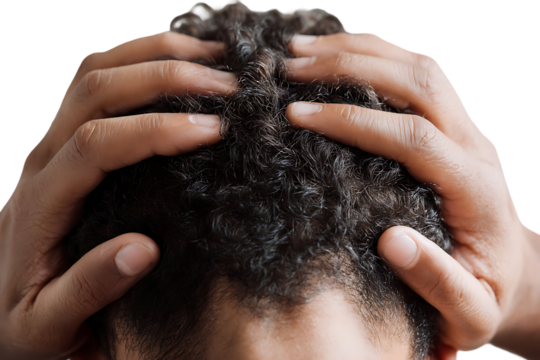 Close up of a person's hands on their head.