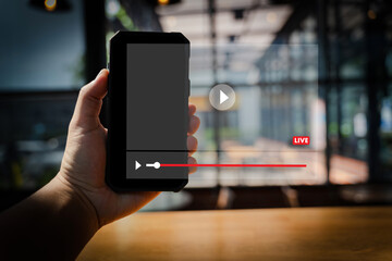 Ott Sharing Video streaming person holding smartphone front of large screen showing live video stream with play button and progress bar