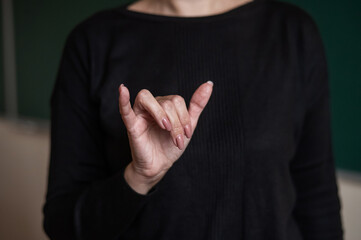 Woman showing the word university in Russian sign language. 