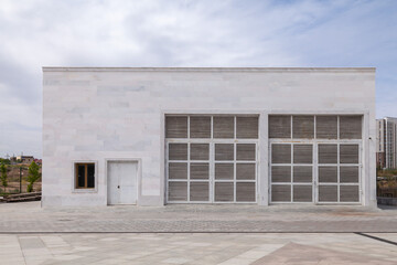 White transformer substation building with white door.