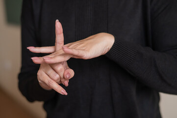 A woman shows the word integration in Russian sign language. 