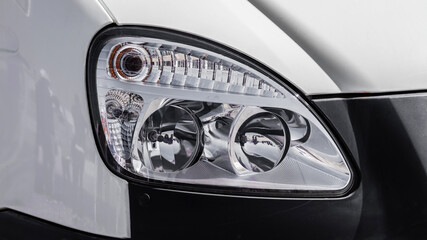 Car headlight with a black rim. The headlight is white
